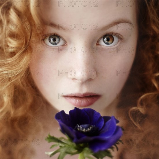 Caucasian teenage girl holding flower