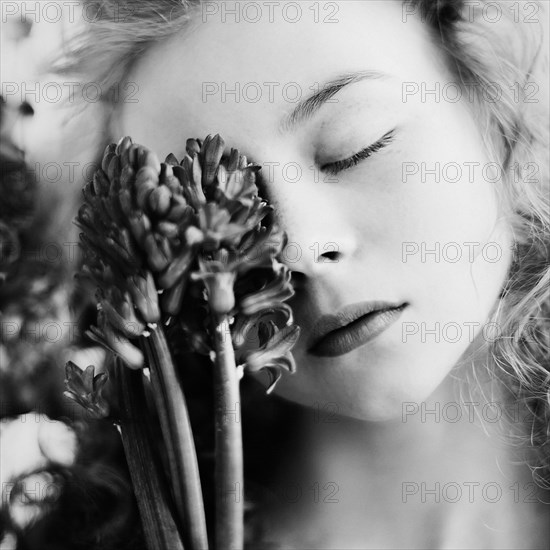 Caucasian teenage girl holding flower