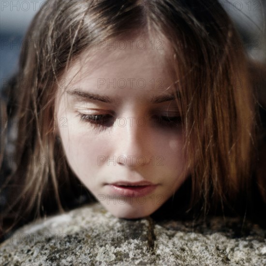 Face of pensive Caucasian girl outdoors