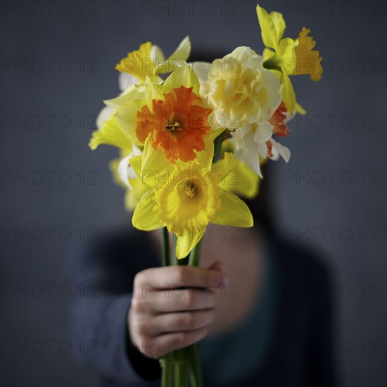 Caucasian girl showing bouquet of flowers