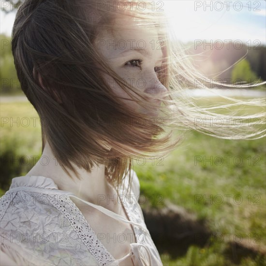 Caucasian girl with hair blowing in wind