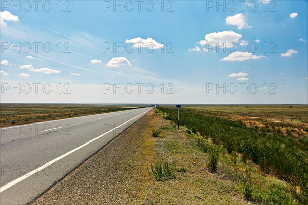 Distant empty highway under blue sky