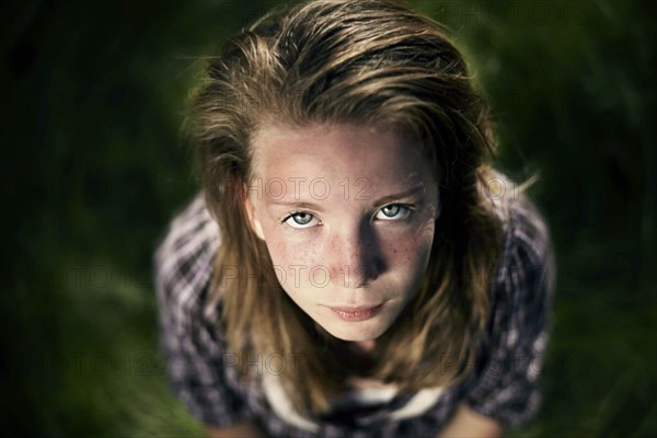 Serious Caucasian girl looking up