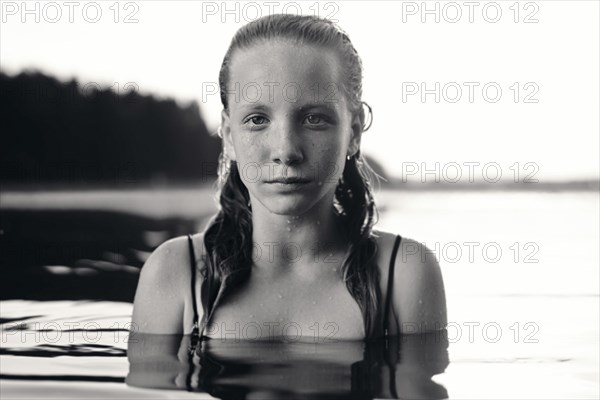 Portrait of serious Caucasian girl in lake
