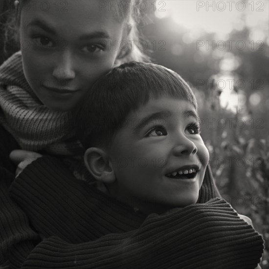 Caucasian women wearing sweater hugging boy