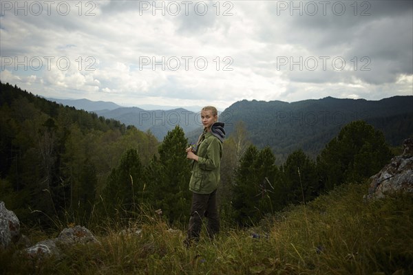 Portrait of Caucasian girl standing on mountain range