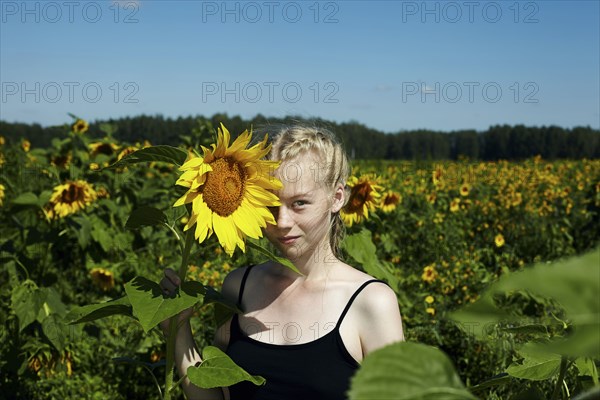 Caucasian girl holding sunflower