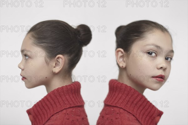 Twin Caucasian girls wearing red sweater