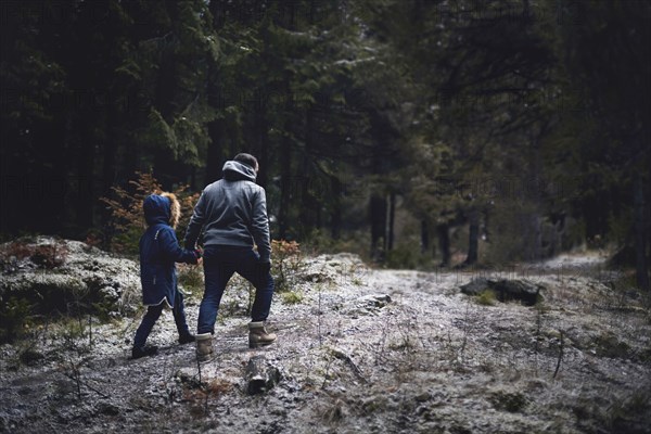 Caucasian father and daughter walking in woods