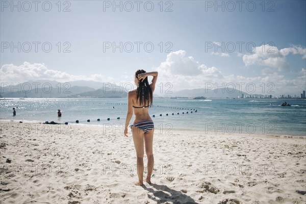 Caucasian woman wearing bikini at beach
