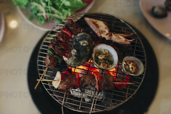 Seafood cooking on grille