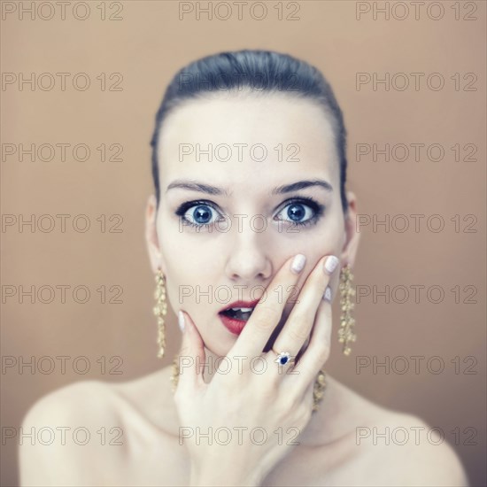 Portrait of surprised Caucasian woman wearing earrings