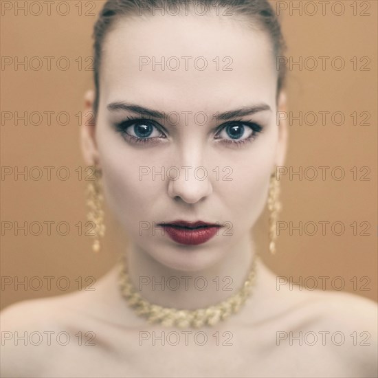 Portrait of serious Caucasian woman wearing earrings and necklace