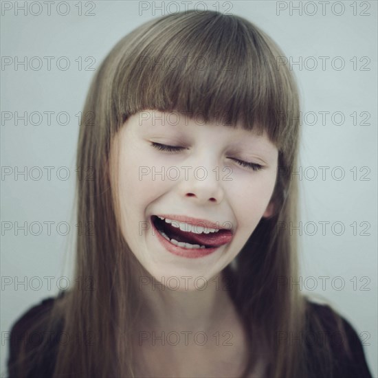 Portrait of Caucasian girl licking lips