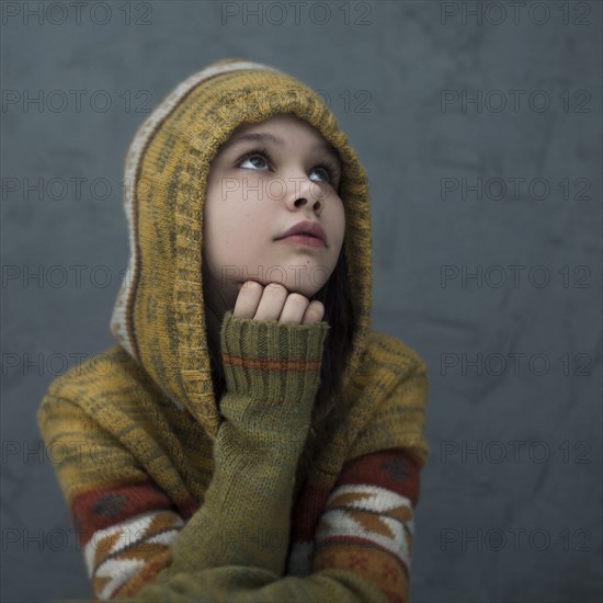 Pensive Caucasian girl wearing hood