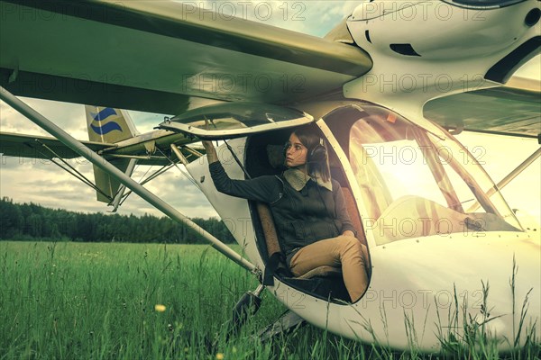 Caucasian woman sitting in airplane cockpit