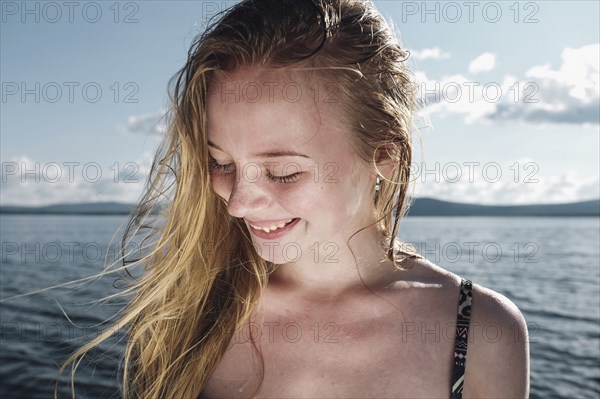 Wind blowing hair of Caucasian teenage girl in ocean