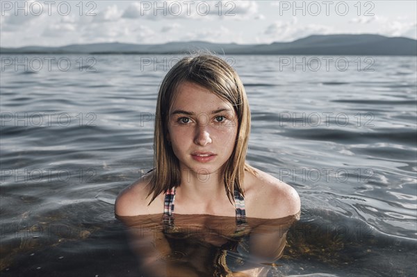 Serious Caucasian woman swimming in ocean