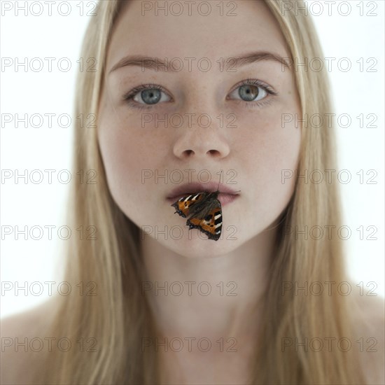 Butterfly on lips of Caucasian teenage girl