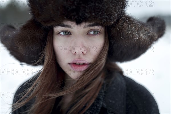 Serious Caucasian woman wearing fur hat and coat in winter