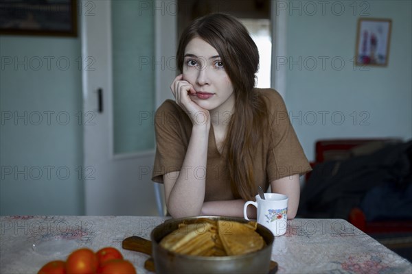 Pensive Caucasian woman sitting at table