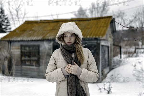 Caucasian woman wearing coat and scarf in winter