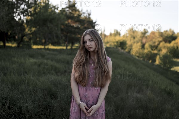 Portrait of serious Caucasian woman standing in field