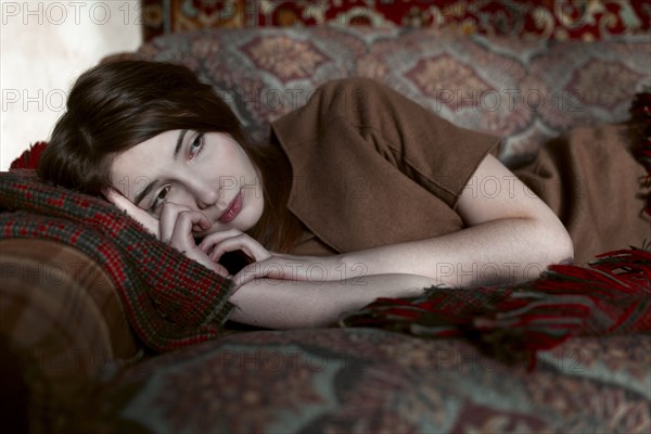 Caucasian woman laying on sofa