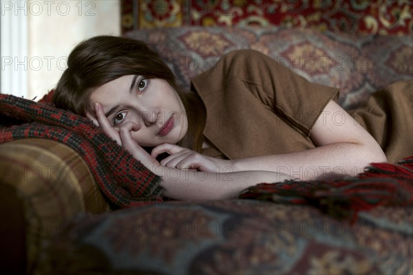 Caucasian woman laying on sofa