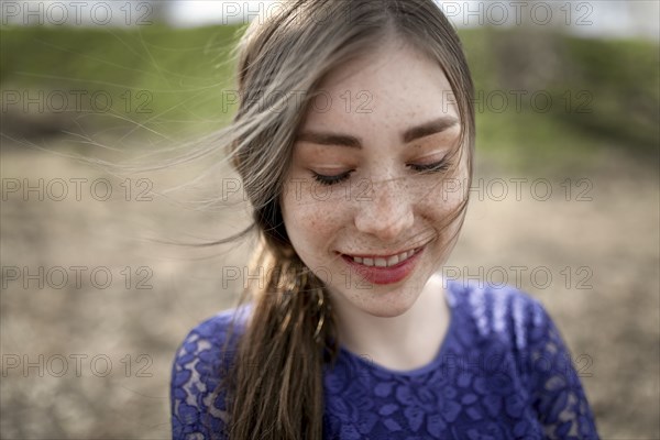 Wind blowing hair of smiling Caucasian woman