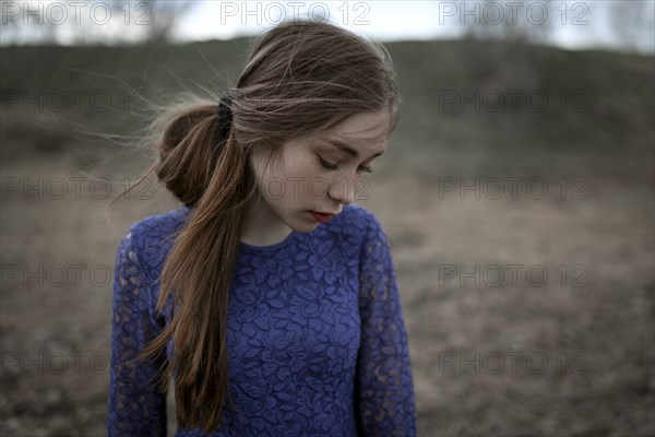 Wind blowing hair of pensive Caucasian woman