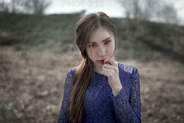 Wind blowing hair of curious Caucasian woman