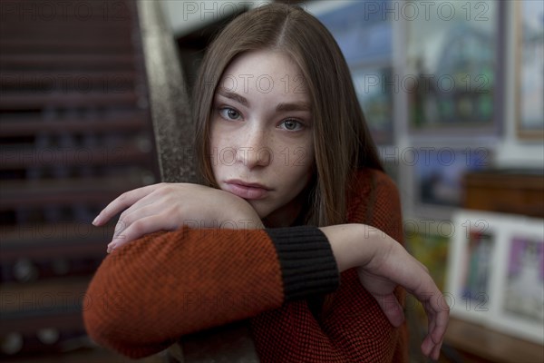 Caucasian woman leaning on staircase railing