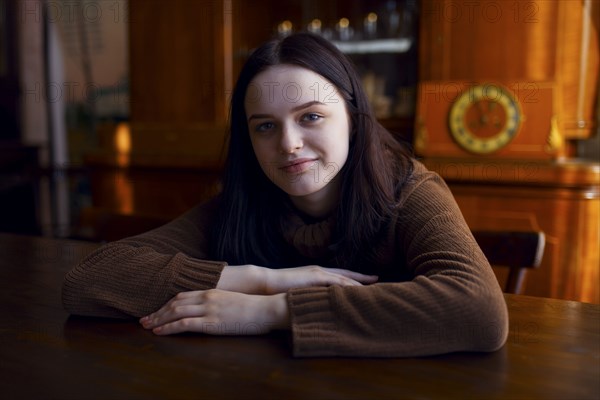 Smiling Caucasian girl sitting at table