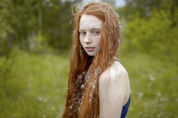 Caucasian girl with dandelion seeds hair