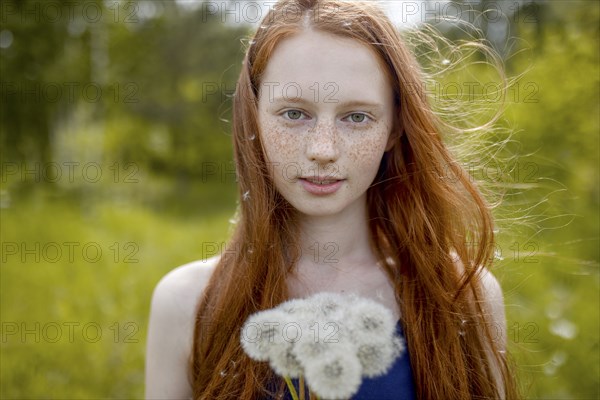 Caucasian girl with dandelion seeds hair