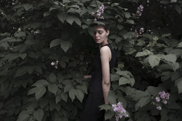 Caucasian woman standing in flowers