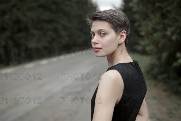 Caucasian woman standing near road