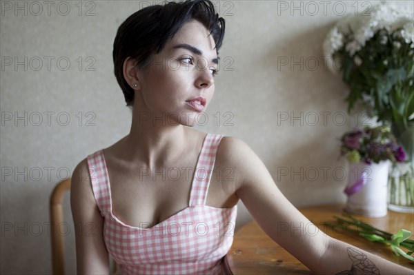 Pensive Caucasian woman sitting at table