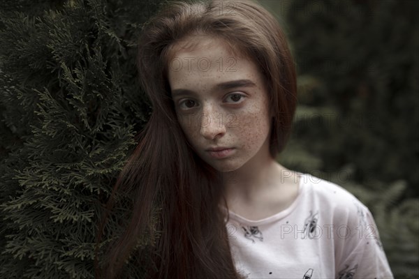 Portrait of serious Caucasian girl with freckles