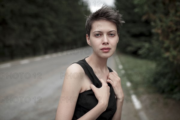 Serious Caucasian woman standing in road