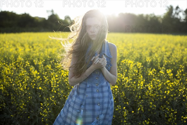 Portrait of Caucasian woman standing in windy field