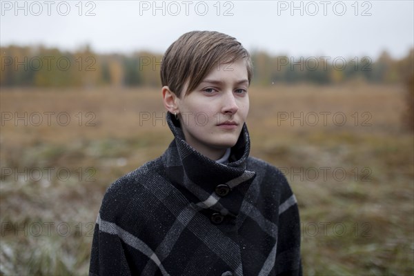 Portrait of serious Caucasian woman standing in field