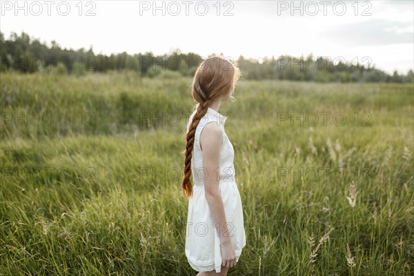 Caucasian girl standing in field
