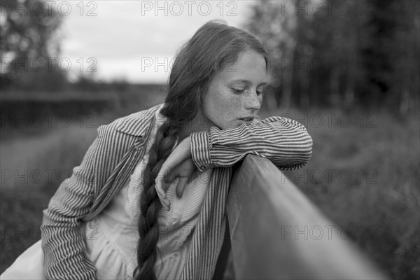 Pensive Caucasian girl sitting on bench