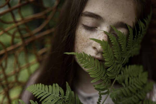 Caucasian Girl Smelling Leaves Photo12 Tetra Images Vyacheslav Chistyakov