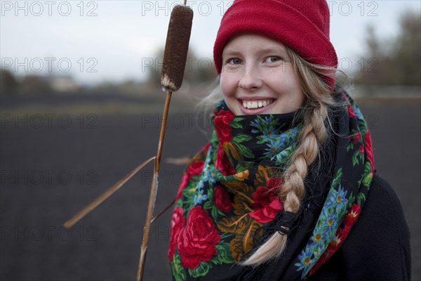 Portrait of smiling Caucasian woman wearing scarf and stocking-cap