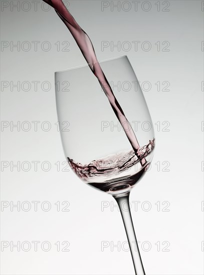 Red wine filling wine glass