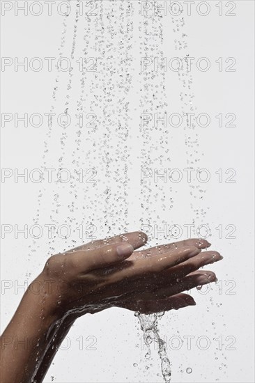 Woman holding hands under shower
