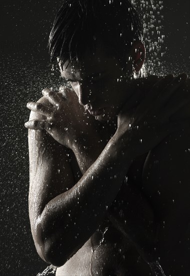 Cold Caucasian man standing in shower